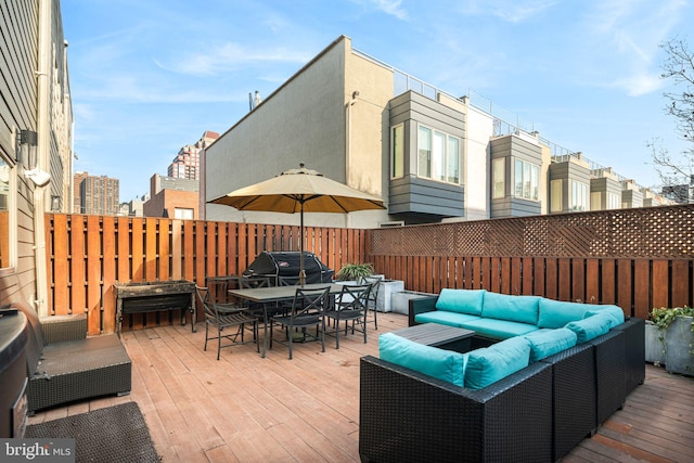 deck featuring an outdoor living space and a grill