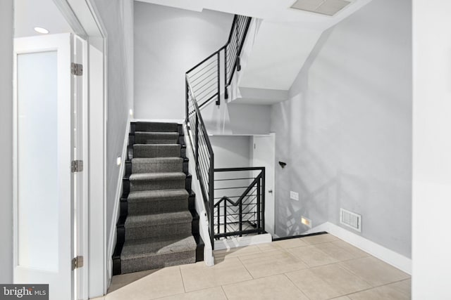 stairway featuring tile patterned flooring