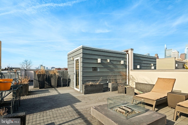 wooden terrace featuring an outdoor fire pit