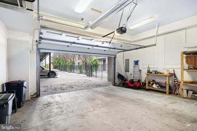 garage with a garage door opener and electric panel