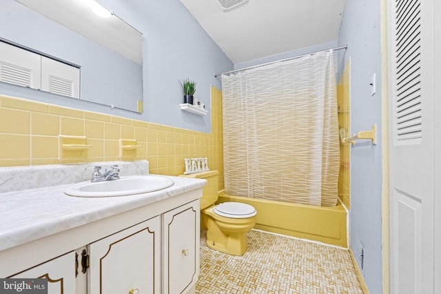 full bathroom with tile walls, shower / tub combo, vanity, tile patterned floors, and toilet