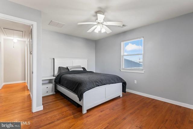 bedroom with hardwood / wood-style floors and ceiling fan