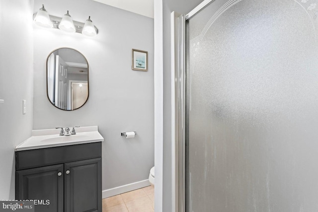 bathroom with vanity, a shower with door, tile patterned floors, and toilet