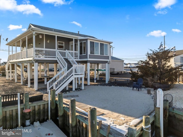 rear view of property featuring a sunroom