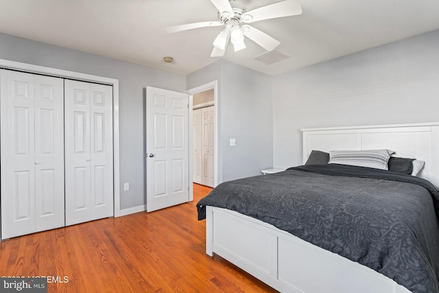 bedroom featuring light hardwood / wood-style floors, a closet, and ceiling fan