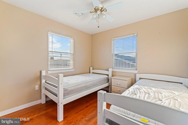 bedroom with hardwood / wood-style floors and ceiling fan