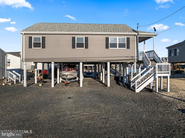 rear view of property featuring a carport