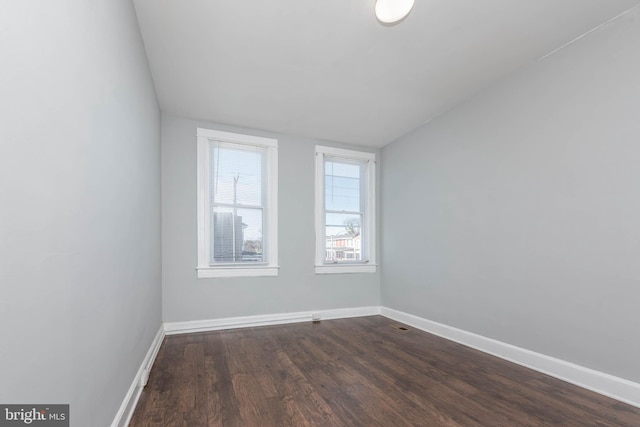 spare room with dark hardwood / wood-style flooring