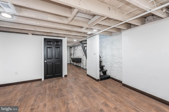 basement with dark wood-type flooring