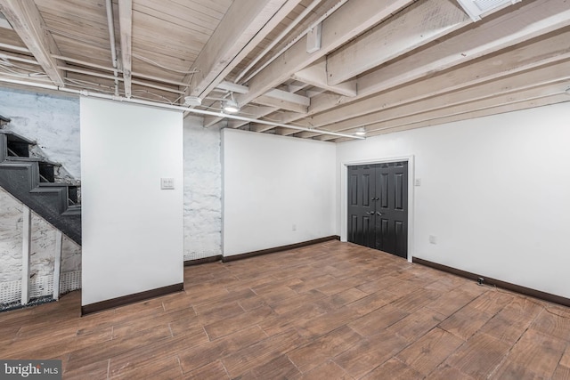 basement with hardwood / wood-style flooring