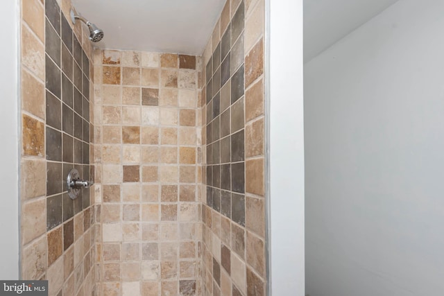 bathroom with tiled shower