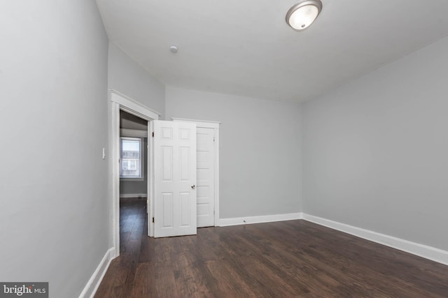 spare room with dark hardwood / wood-style floors