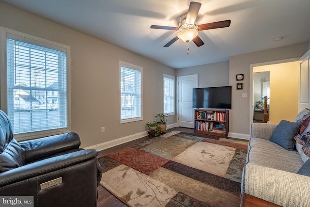 living room featuring dark hardwood / wood-style flooring and ceiling fan