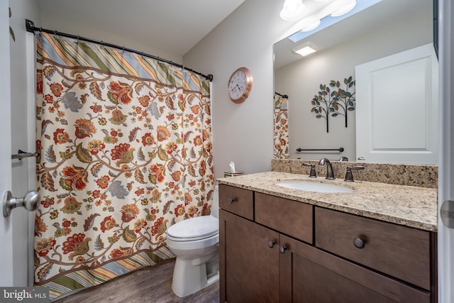 bathroom featuring hardwood / wood-style flooring, vanity, and toilet