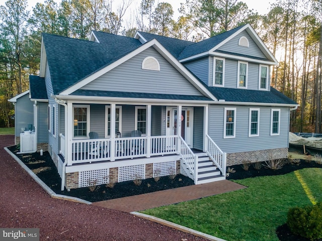 view of front facade with covered porch and a front yard