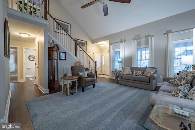 living room with ceiling fan, dark hardwood / wood-style floors, and high vaulted ceiling