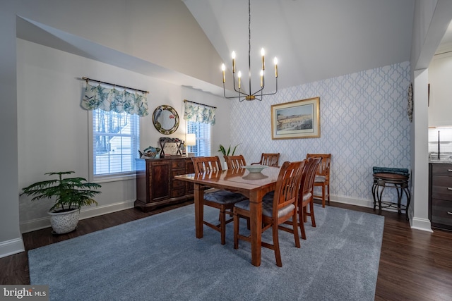 dining area featuring dark hardwood / wood-style flooring, high vaulted ceiling, and an inviting chandelier