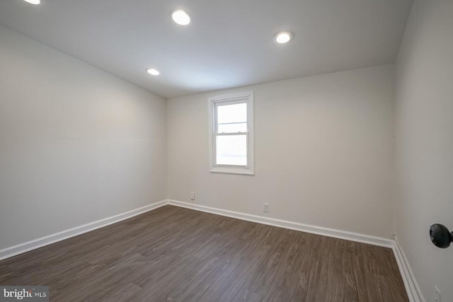 empty room with dark hardwood / wood-style flooring