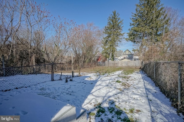 view of yard layered in snow