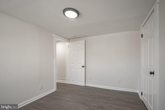 empty room featuring dark hardwood / wood-style flooring