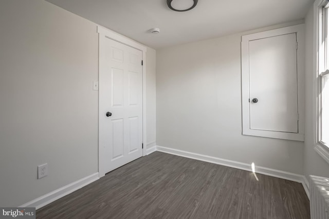 unfurnished bedroom featuring dark hardwood / wood-style floors