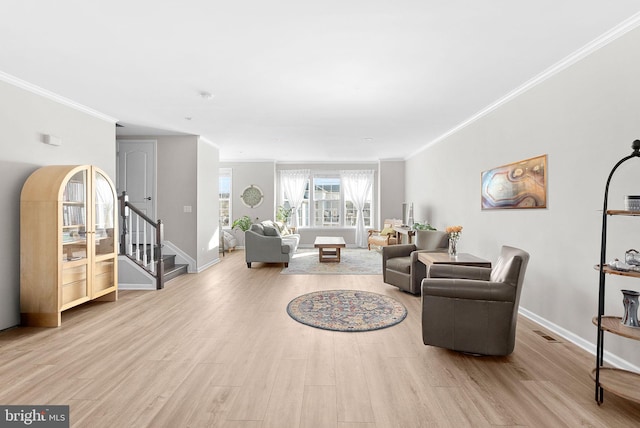 living room featuring crown molding and light hardwood / wood-style floors