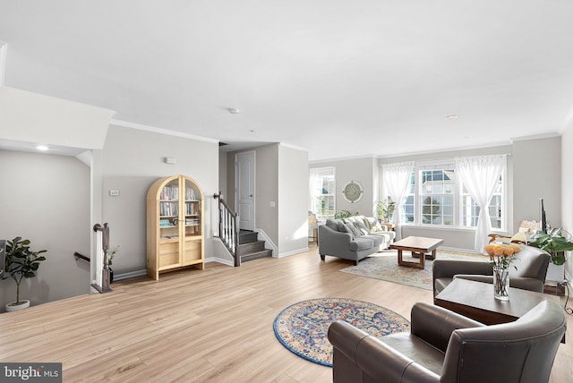 living room featuring light hardwood / wood-style flooring and crown molding