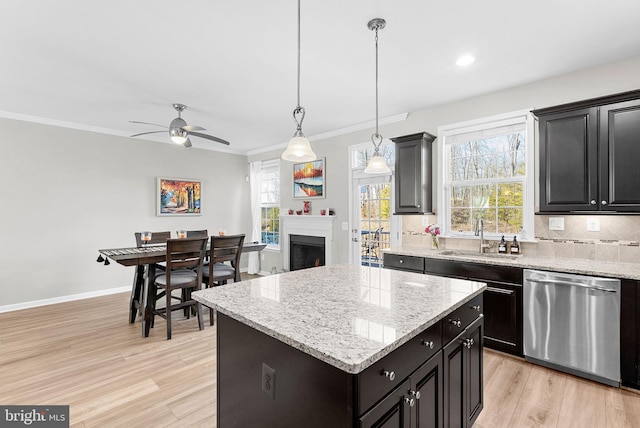 kitchen with sink, a center island, pendant lighting, dishwasher, and light wood-type flooring