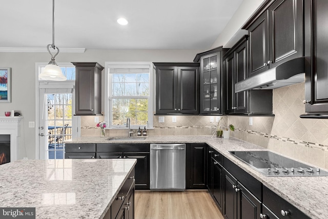 kitchen featuring light hardwood / wood-style flooring, dishwasher, black electric stovetop, pendant lighting, and sink