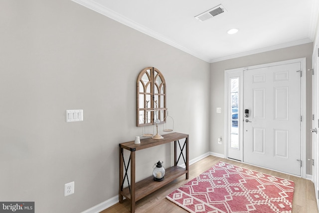 foyer with wood-type flooring and ornamental molding