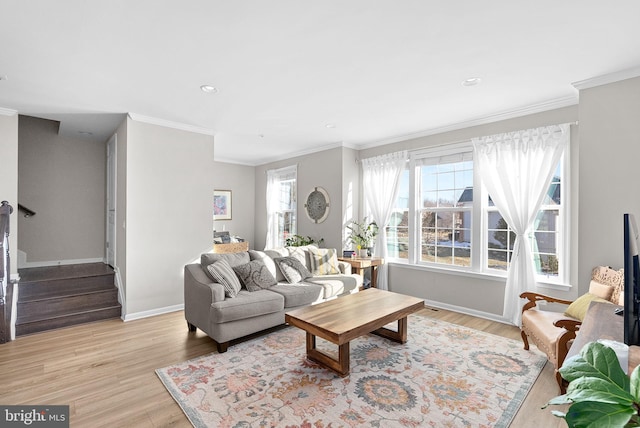 living room featuring light hardwood / wood-style flooring and crown molding