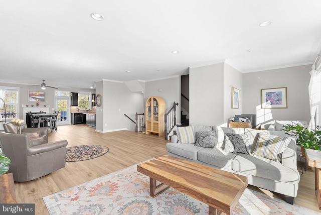 living room featuring light hardwood / wood-style floors and crown molding