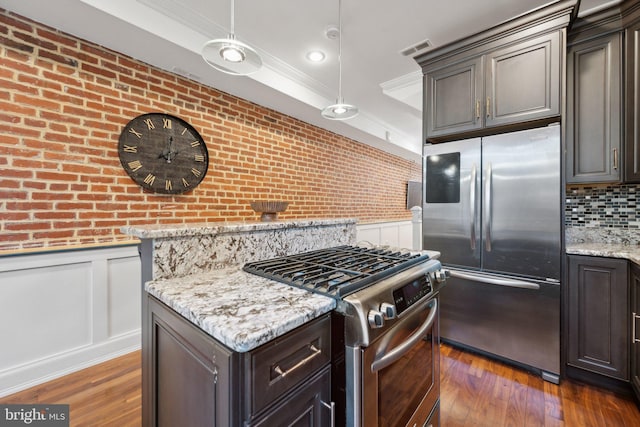 kitchen featuring hanging light fixtures, dark wood-type flooring, dark brown cabinets, and appliances with stainless steel finishes