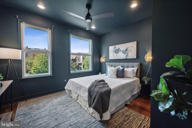 bedroom with dark wood-type flooring and ceiling fan