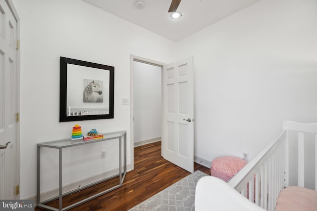 bedroom with dark hardwood / wood-style flooring