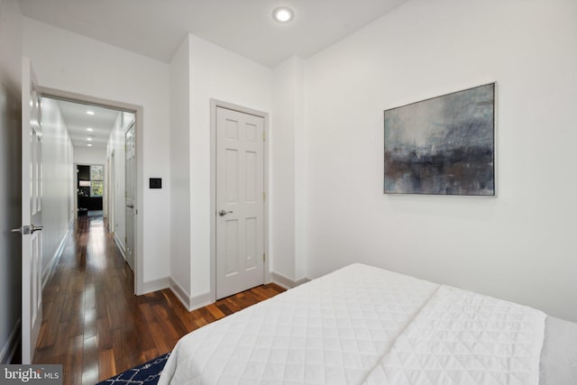 bedroom with dark hardwood / wood-style floors