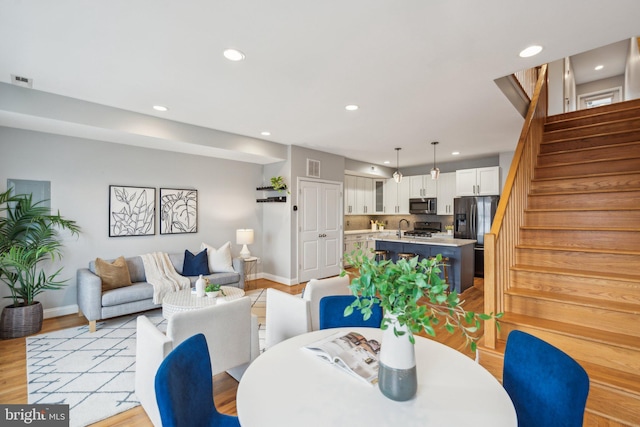 dining room featuring sink and light hardwood / wood-style floors