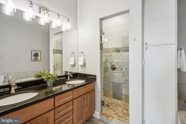 bathroom featuring vanity and a shower with shower door