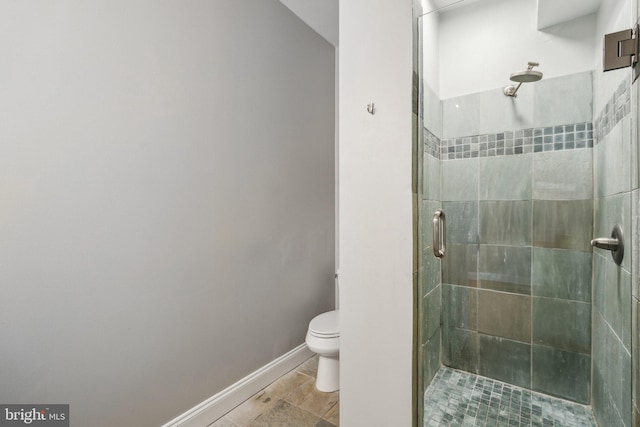 bathroom with an enclosed shower and toilet