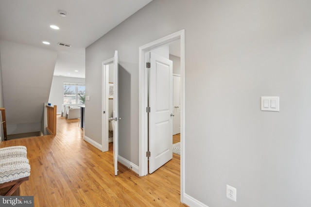 hall with light hardwood / wood-style flooring