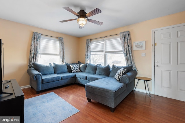 living room with dark hardwood / wood-style floors and ceiling fan