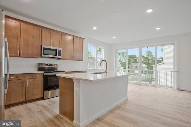 18 Aspen Dr, North East, MD 21901 - kitchen with stainless steel appliances, light wood-style flooring, a sink, light countertops, and brown cabinetry