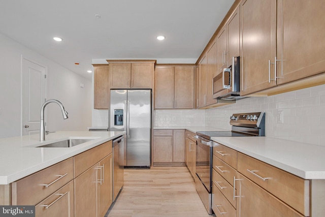 18 Aspen Dr, North East, MD 21901 - kitchen with appliances with stainless steel finishes, a sink, light wood-style flooring, backsplash, and recessed lighting