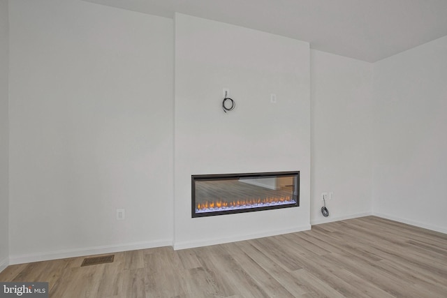 18 Aspen Dr, North East, MD 21901 - detailed view of a glass covered fireplace, wood finished floors, and baseboards
