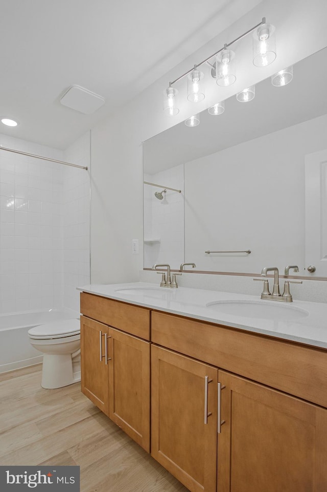 18 Aspen Dr, North East, MD 21901 - bathroom with double vanity, wood finished floors, toilet, and  shower combination