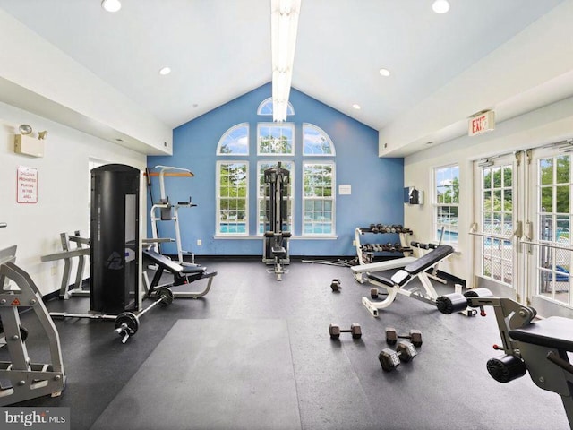 exercise room featuring vaulted ceiling and french doors