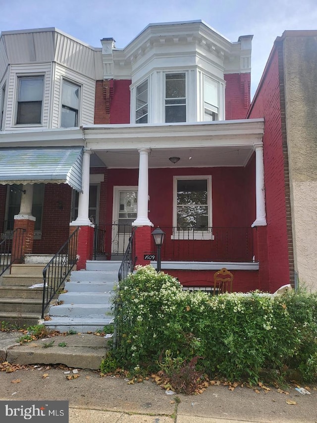 view of property featuring covered porch