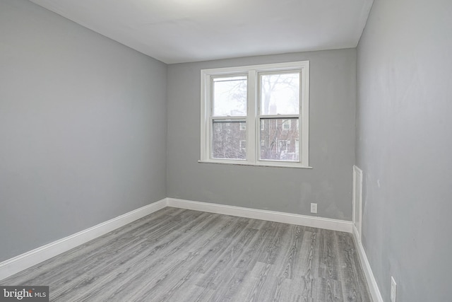 unfurnished room with light hardwood / wood-style flooring