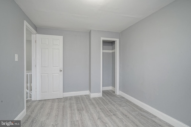 unfurnished bedroom with a closet and light hardwood / wood-style flooring