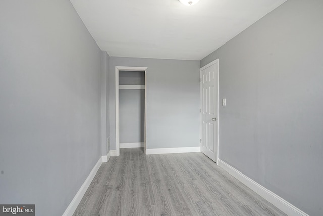 unfurnished bedroom featuring a closet and light hardwood / wood-style flooring